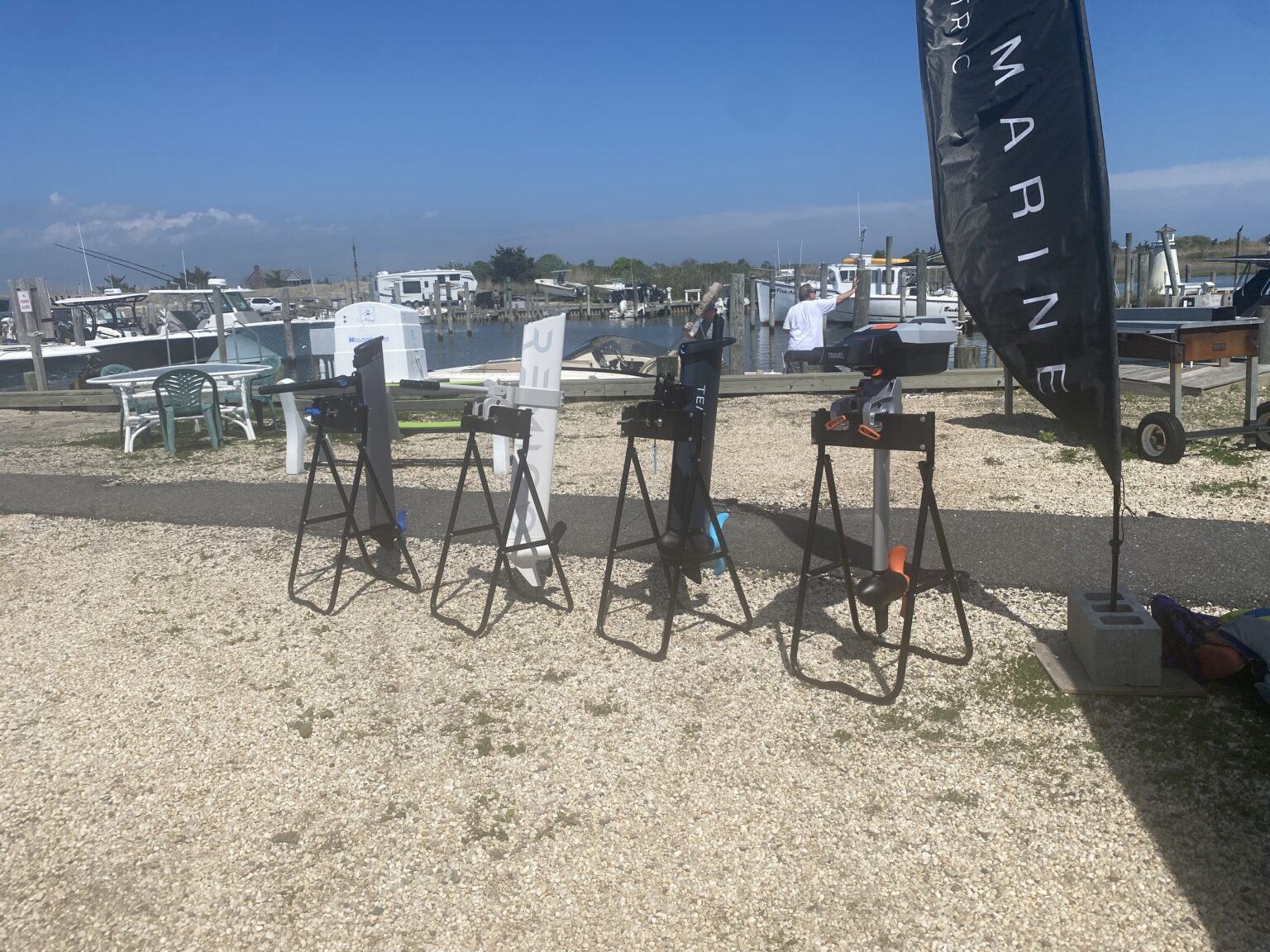 four electric outboard motors on stands