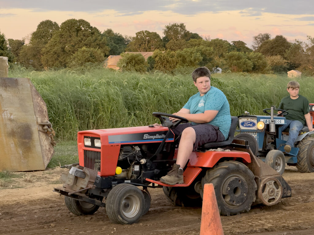 Junior puller Michael Barry wears a blue shirt and digs in with his 72-year-old red Panzer tractor.