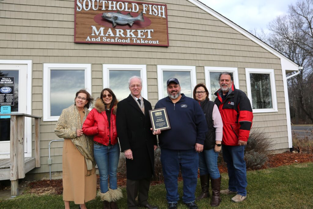 Charlie Manwaring, with wife Rebecca (second from right) were honored by Stony Brook Eastern Long Island Hospital's (from left) Linda Sweeney, Sheri Winter Parker, Paul Connor and Paul Romanelli. (Credit: Edward Glazarev photo)